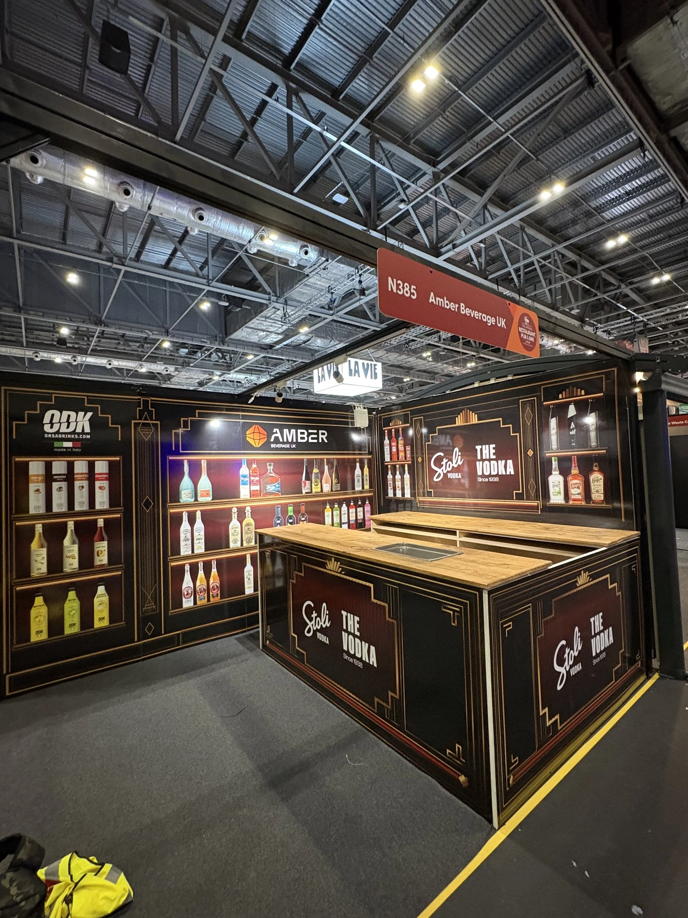 The built London stand, with the wall graphics and bar treatment from the visualisation.